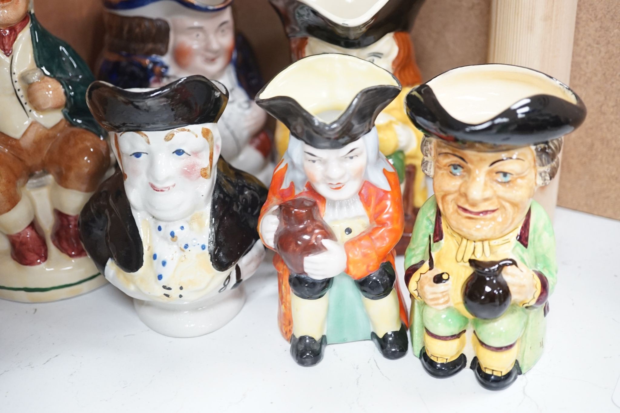 A Sylvac Coachman Toby jug, and eleven others, tallest 17cm